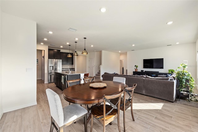 1487 NW 136th Blvd, Newberry, FL 32669 - dining area with recessed lighting, light wood-style flooring, and stairway