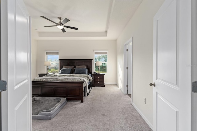 1487 NW 136th Blvd, Newberry, FL 32669 - bedroom with baseboards, carpet floors, a tray ceiling, and a ceiling fan