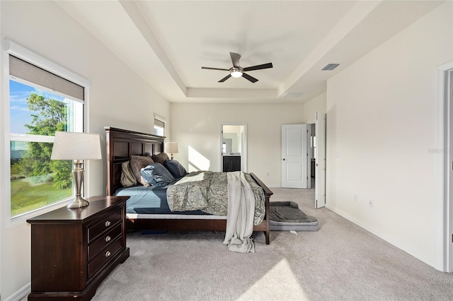 1487 NW 136th Blvd, Newberry, FL 32669 - bedroom featuring a tray ceiling, baseboards, visible vents, a ceiling fan, and light carpet