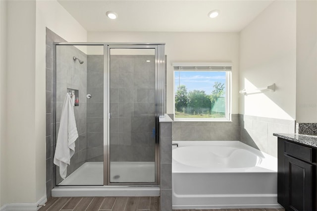 1487 NW 136th Blvd, Newberry, FL 32669 - full bath featuring vanity, a bath, a stall shower, and wood finished floors