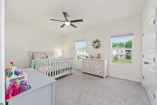 1487 NW 136th Blvd, Newberry, FL 32669 - bedroom with baseboards, ceiling fan, a closet, and light carpet