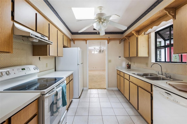 4038 NW 86th Blvd, Gainesville, FL 32653 - kitchen with white appliances, under cabinet range hood, light countertops, light tile patterned floors, and crown molding