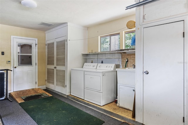 4038 NW 86th Blvd, Gainesville, FL 32653 - laundry room with washing machine and dryer and cabinet space