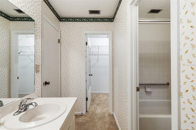 4038 NW 86th Blvd, Gainesville, FL 32653 - full bath with wallpapered walls, vanity, a spacious closet, and bathing tub / shower combination