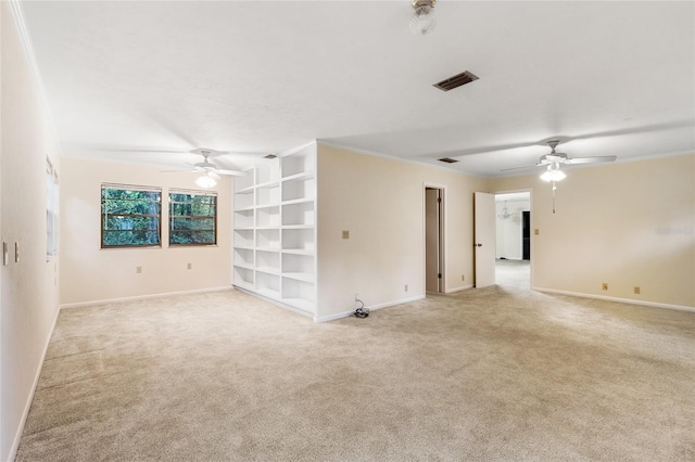 4038 NW 86th Blvd, Gainesville, FL 32653 - spare room featuring ceiling fan, light colored carpet, built in shelves, and crown molding