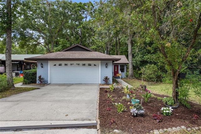 4038 NW 86th Blvd, Gainesville, FL 32653 - ranch-style house with stucco siding, concrete driveway, an attached garage, and a shingled roof