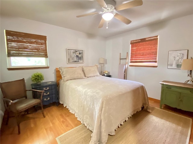 bedroom with ceiling fan and light wood-style flooring