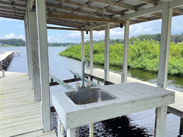 dock area featuring a water view and a sink