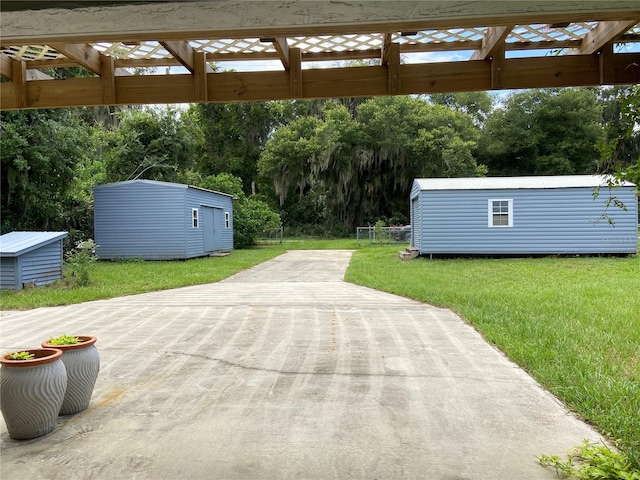 view of patio featuring a storage unit and an outdoor structure