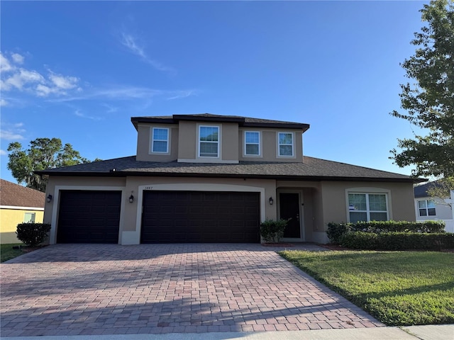 3447 Cypress Grove Dr, Eustis, FL 32736 - view of front of property featuring stucco siding, decorative driveway, a front yard, and a garage