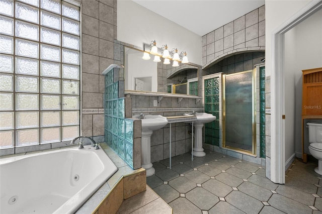 full bath featuring a stall shower, a wealth of natural light, toilet, and tile walls