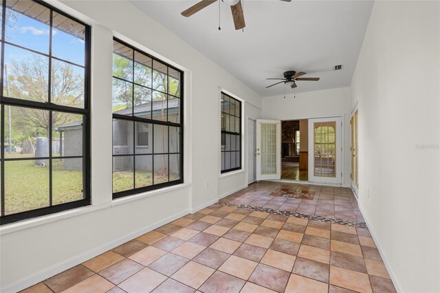 unfurnished sunroom featuring visible vents