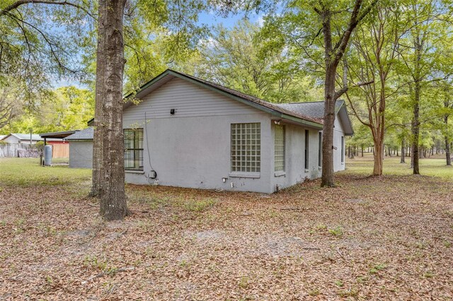 view of side of home with stucco siding