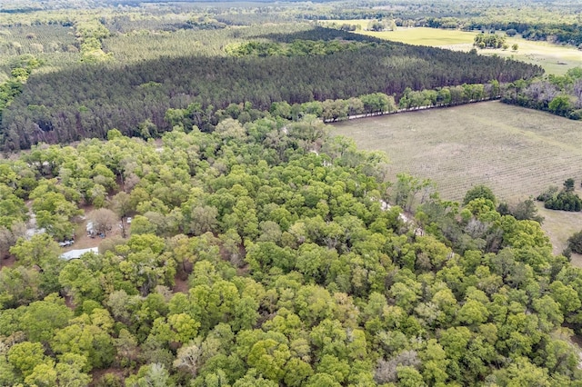 bird's eye view with a wooded view