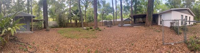 view of yard featuring a sunroom and a fenced backyard