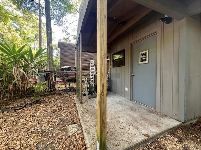 view of exterior entry featuring fence