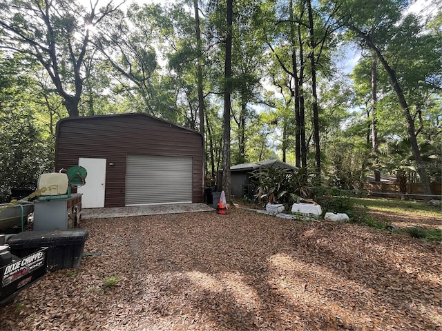 detached garage with dirt driveway