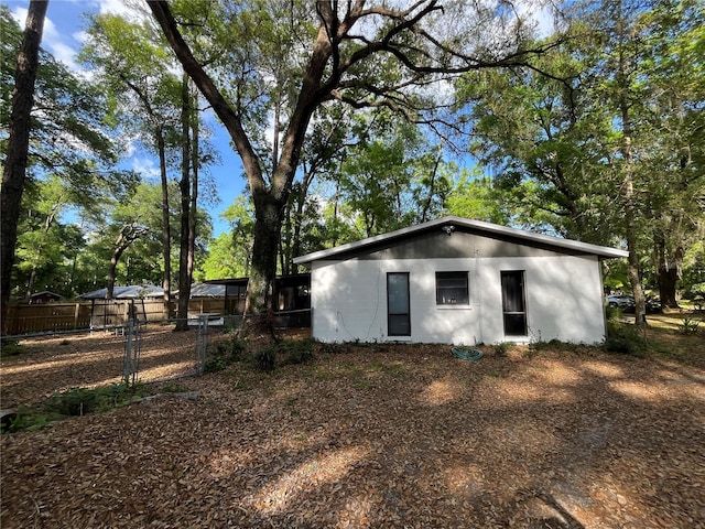 view of property exterior featuring a gate and fence