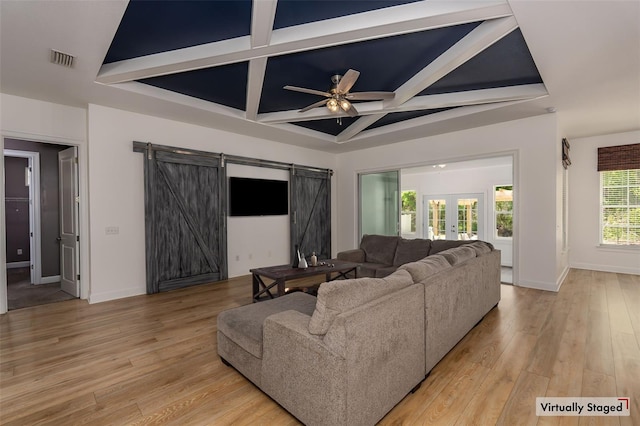 living area featuring visible vents, ceiling fan, a barn door, french doors, and coffered ceiling