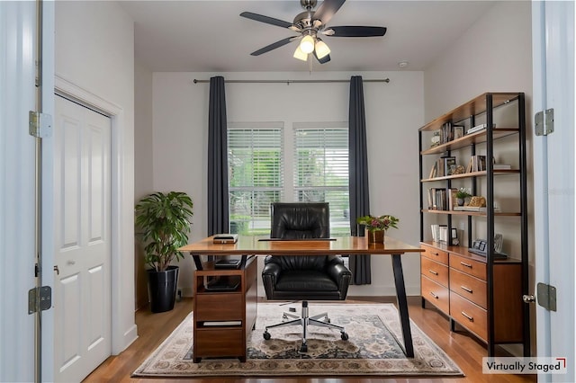 office with a ceiling fan and wood finished floors