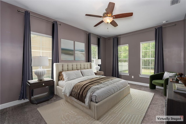 bedroom featuring visible vents, a ceiling fan, carpet, and baseboards