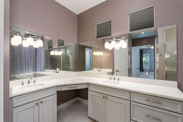 full bath with double vanity, a sink, and marble finish floor