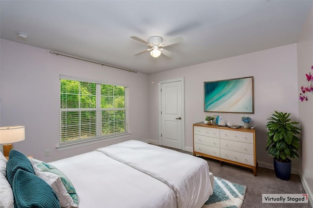carpeted bedroom with baseboards and a ceiling fan