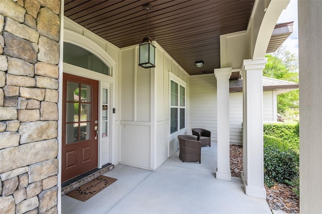 property entrance featuring board and batten siding and stone siding