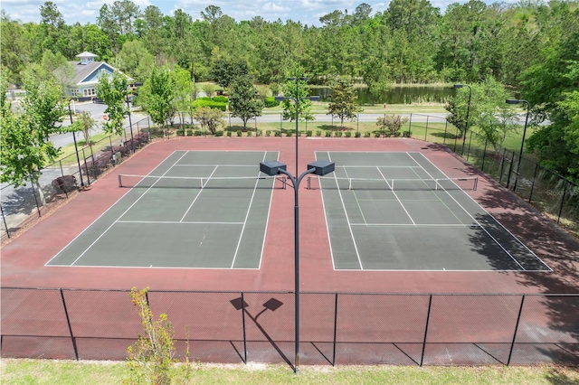 view of tennis court featuring fence