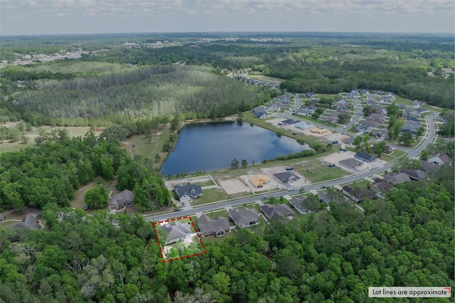 drone / aerial view with a residential view, a water view, and a forest view