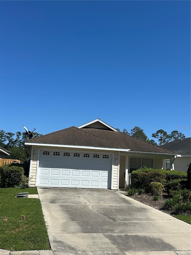 11747 NW 61st Ter, Alachua, FL 32615 - view of front of home with concrete driveway, a garage, and a front yard