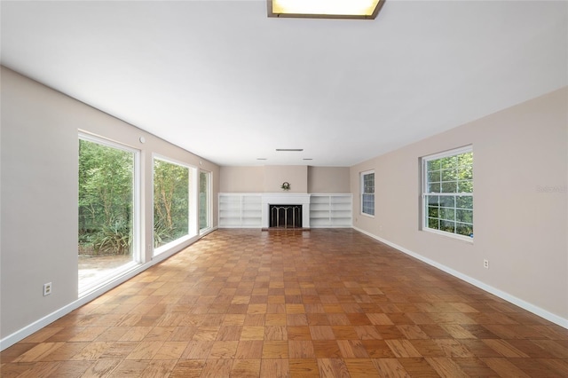 1711 NW 10th Ave, Gainesville, FL 32605 - unfurnished living room featuring plenty of natural light and baseboards