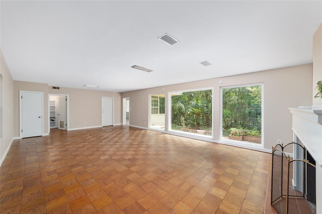 1711 NW 10th Ave, Gainesville, FL 32605 - unfurnished living room with baseboards and a fireplace