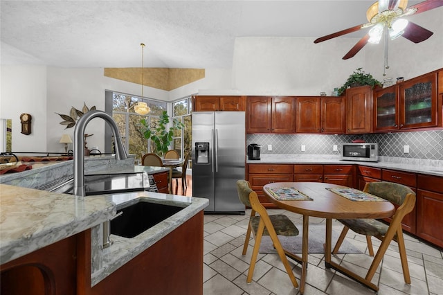 4250 NW 81st Ln, Bell, FL 32619 - kitchen featuring stainless steel fridge with ice dispenser, backsplash, decorative light fixtures, and a sink