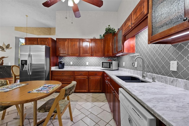 4250 NW 81st Ln, Bell, FL 32619 - kitchen featuring light tile patterned floors, a sink, appliances with stainless steel finishes, a ceiling fan, and backsplash