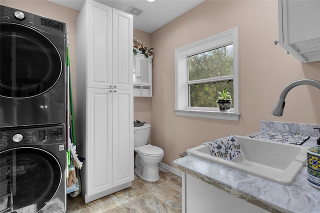 4250 NW 81st Ln, Bell, FL 32619 - laundry area with laundry area, stacked washer and dryer, visible vents, a sink, and baseboards