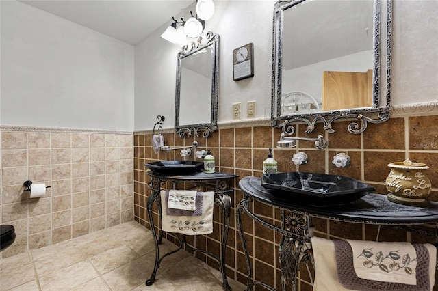 4250 NW 81st Ln, Bell, FL 32619 - bathroom featuring tile patterned floors, tile walls, a sink, and a wainscoted wall