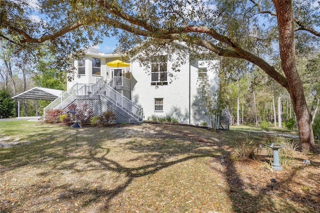 4250 NW 81st Ln, Bell, FL 32619 - rear view of house with stucco siding and stairs