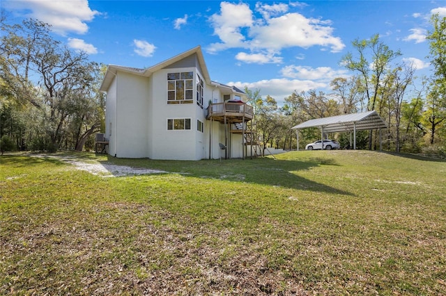 4250 NW 81st Ln, Bell, FL 32619 - back of property featuring a carport, a wooden deck, a lawn, and stucco siding