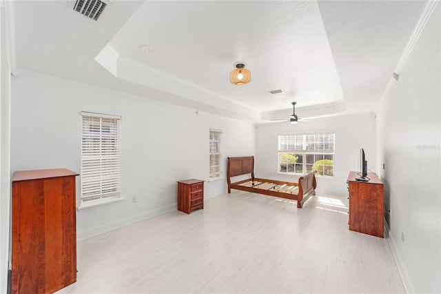 11764 NW 60th Dr, Alachua, FL 32615 - bedroom featuring a tray ceiling, light wood-type flooring, and baseboards