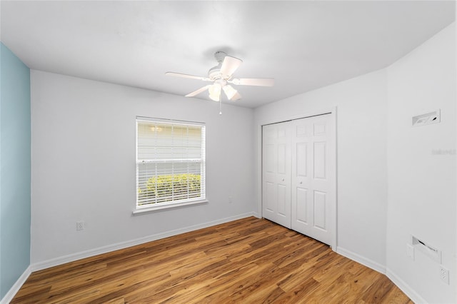 11764 NW 60th Dr, Alachua, FL 32615 - unfurnished bedroom featuring wood finished floors, baseboards, a closet, and ceiling fan