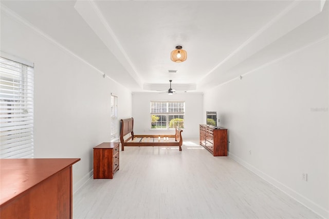 11764 NW 60th Dr, Alachua, FL 32615 - bedroom with a tray ceiling, light wood-style flooring, and baseboards