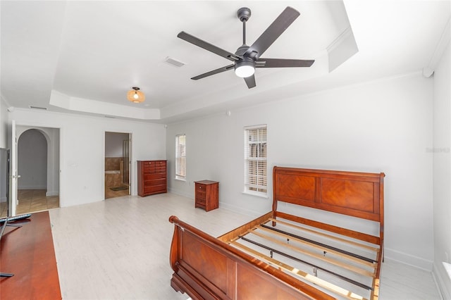 11764 NW 60th Dr, Alachua, FL 32615 - bedroom with a raised ceiling, crown molding, wood finished floors, baseboards, and arched walkways