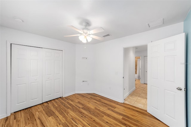 11764 NW 60th Dr, Alachua, FL 32615 - unfurnished bedroom featuring light wood-type flooring, baseboards, a closet, and ceiling fan