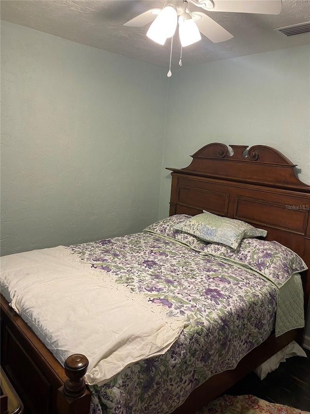 bedroom featuring ceiling fan and visible vents