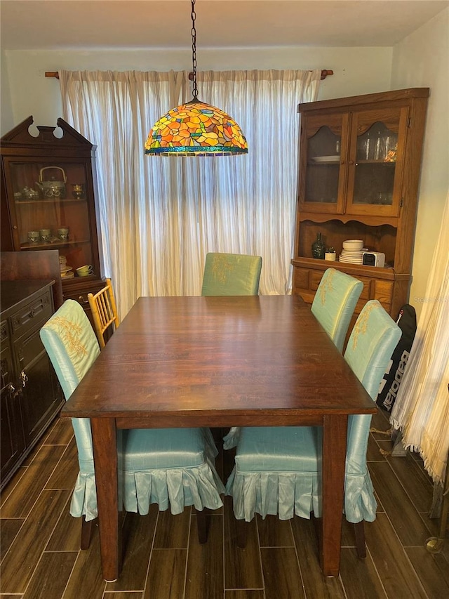 dining space featuring wood tiled floor