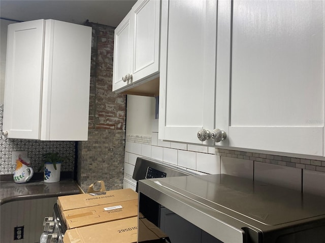 kitchen with decorative backsplash and white cabinetry