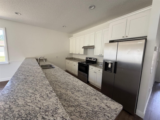 kitchen featuring appliances with stainless steel finishes, a sink, a textured ceiling, under cabinet range hood, and dark wood-style floors