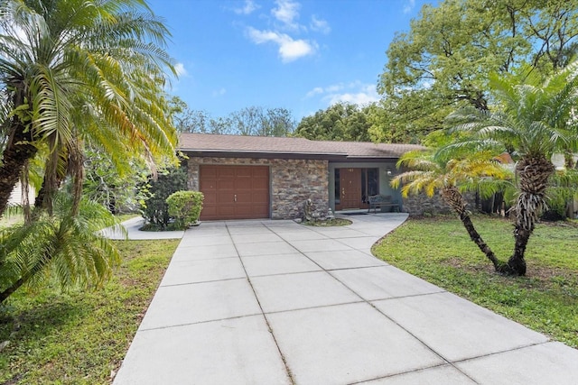 841 N Palm Springs Ter, Crystal River, FL 34429 - view of front of property with a garage, stone siding, driveway, and a front lawn