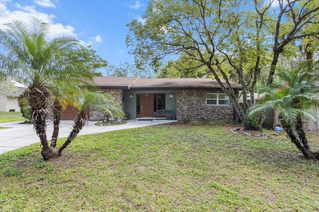 841 N Palm Springs Ter, Crystal River, FL 34429 - view of front of home featuring a garage, a front yard, driveway, and stone siding